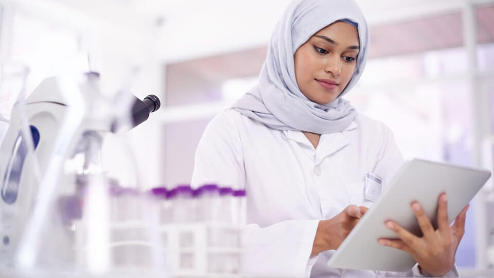 Shot of a young scientist using a digital tablet in a lab