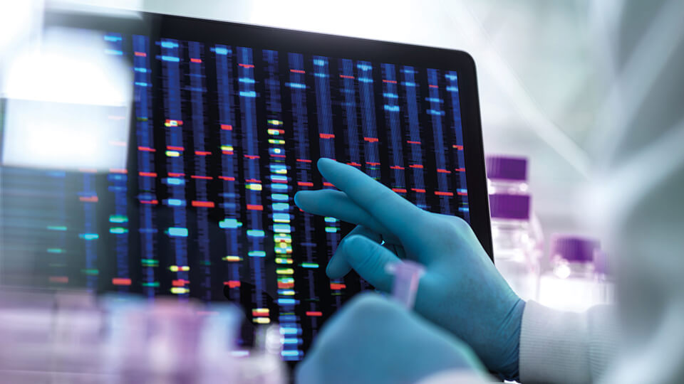 Scientist examining DNA (deoxyribonucleic acid) results on a screen during an experiment in the laboratory